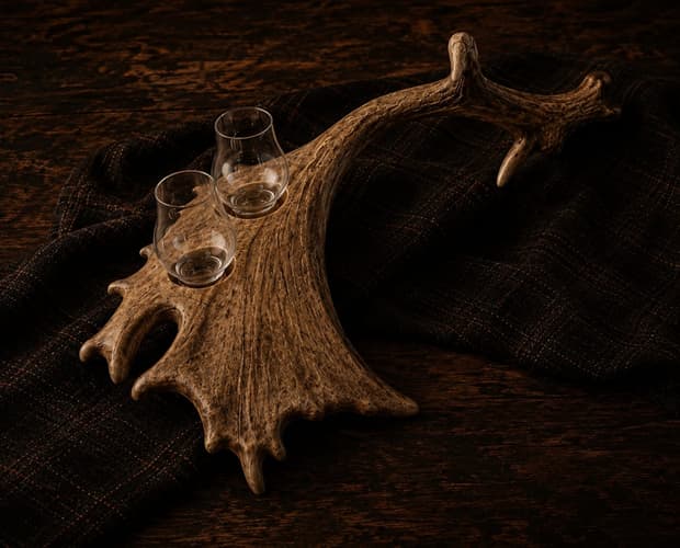 A single naturally shed antler palm with Glencairn glasses seated in it